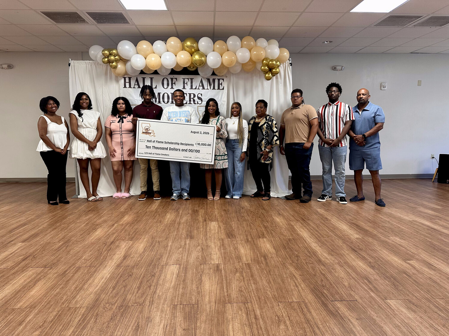 The 2026 scholarship recipients and their families with the Hall of Flame Smokers