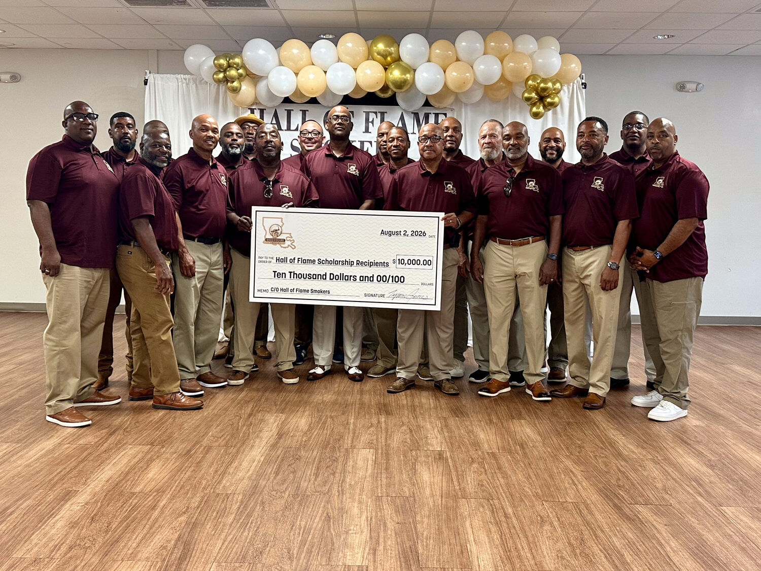 Members of the Hall of Flame Smokers with the $10,000 ceremonial scholarship check