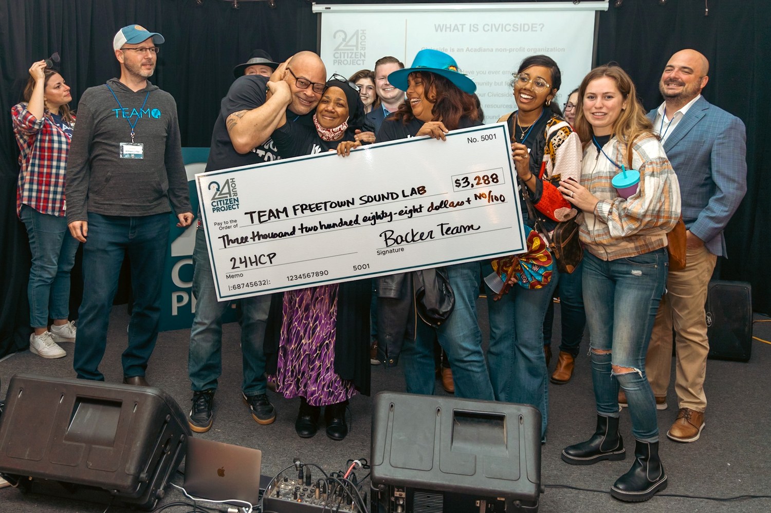 Team Freetown Sound Lab at the 24 Hour Citizen Project in Lafayette, holding an oversized check